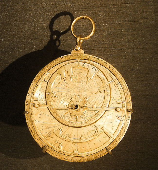 An old brass astrolabe, with Arabic markings.